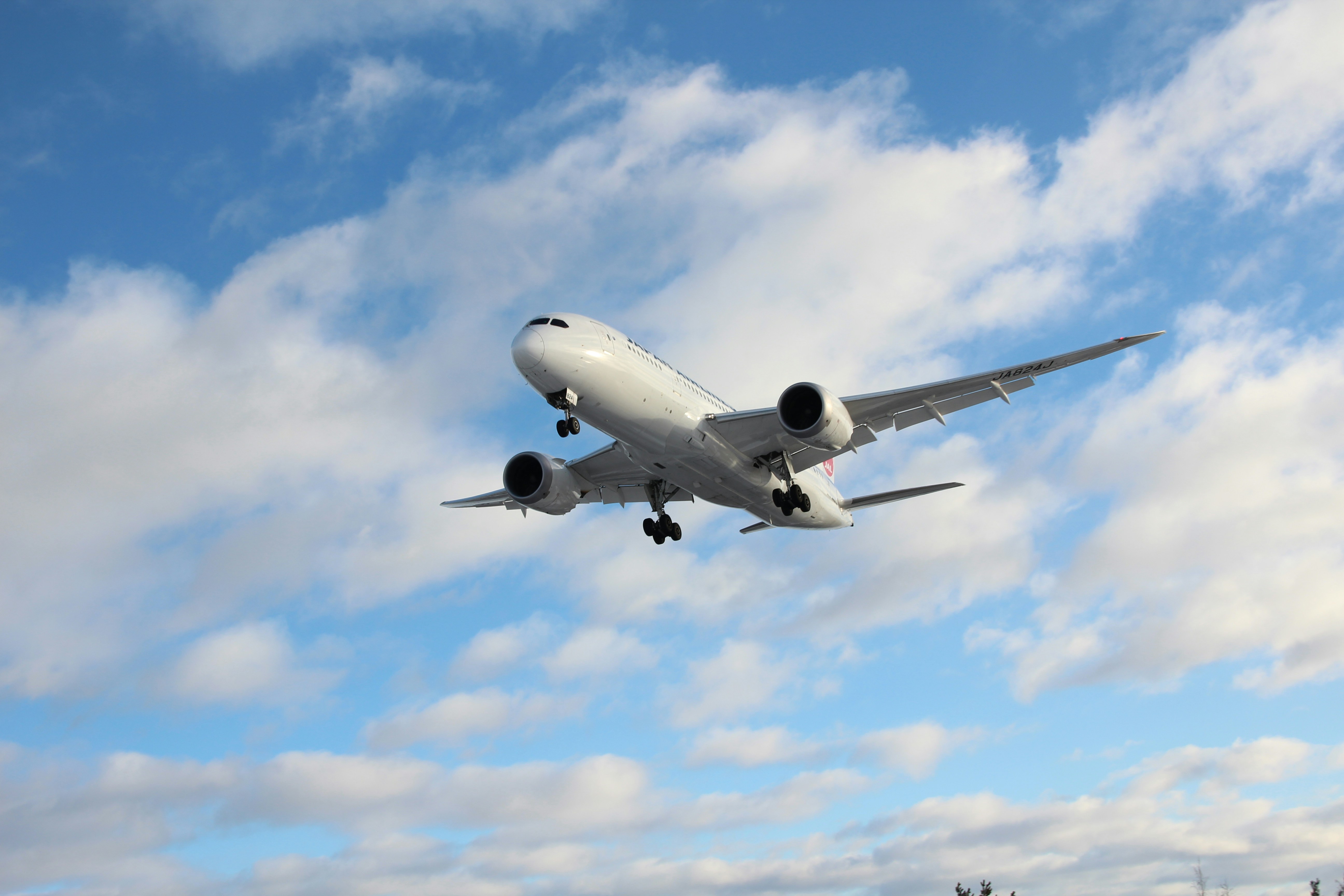 white airplane under blue sky during daytime